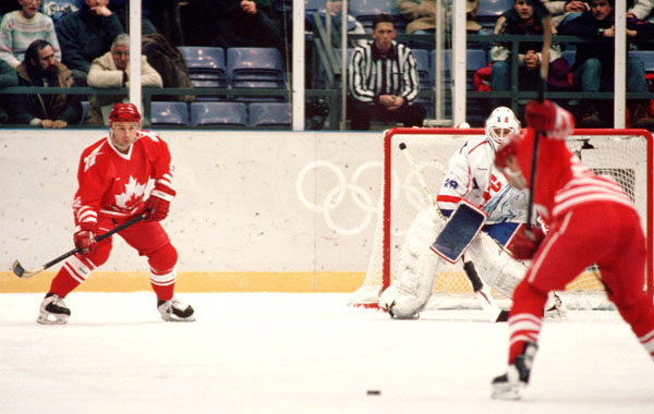 Canada's Wally Schreiber (left) competes in hockey action at the 1994 Winter Olympics in Lillehammer. (CP Photo/COA/Claus Andersen)