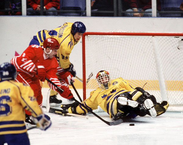 Canada's Todd Hlushko (red) competes in hockey action at the 1994 Winter Olympics in Lillehammer. (CP Photo/COA/Claus Andersen)