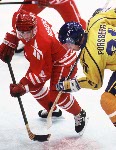 Canada's Fabian Joseph (right) competes in hockey action against Sweden at the 1994 Winter Olympics in Lillehammer. (CP Photo/COA/Claus Andersen)