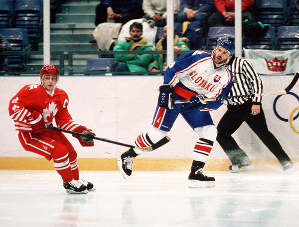 Canada's Fabian Joseph (left) participates in hockey action against Slovakia at the 1994 Winter Olympics in Lillehammer. (CP Photo/COA/Claus Andersen)