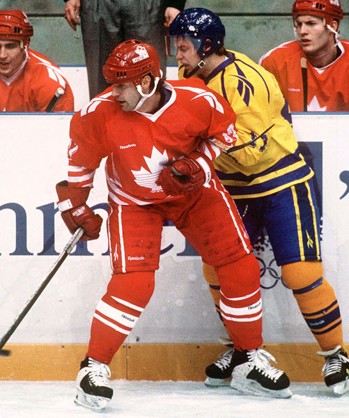 Canada's Chris Kontos (left) competes in hockey action against Sweden at the 1994 Winter Olympics in Lillehammer. (CP Photo/COA/Claus Andersen)
