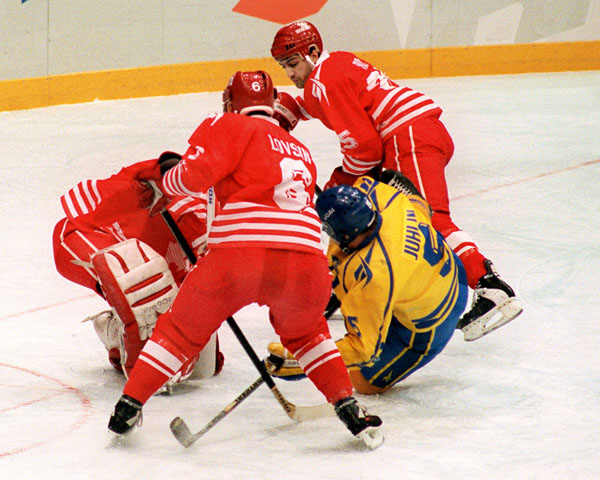 Canada's Ken Lovsin (left) and Brad Werenka compete in hockey action against Sweden at the 1994 Winter Olympics in Lillehammer. (CP Photo/COA/Claus Andersen)