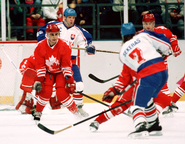Canada's Ken Lovsin (left) competes in hockey action at the 1994 Winter Olympics in Lillehammer. (CP Photo/COA/Claus Andersen)