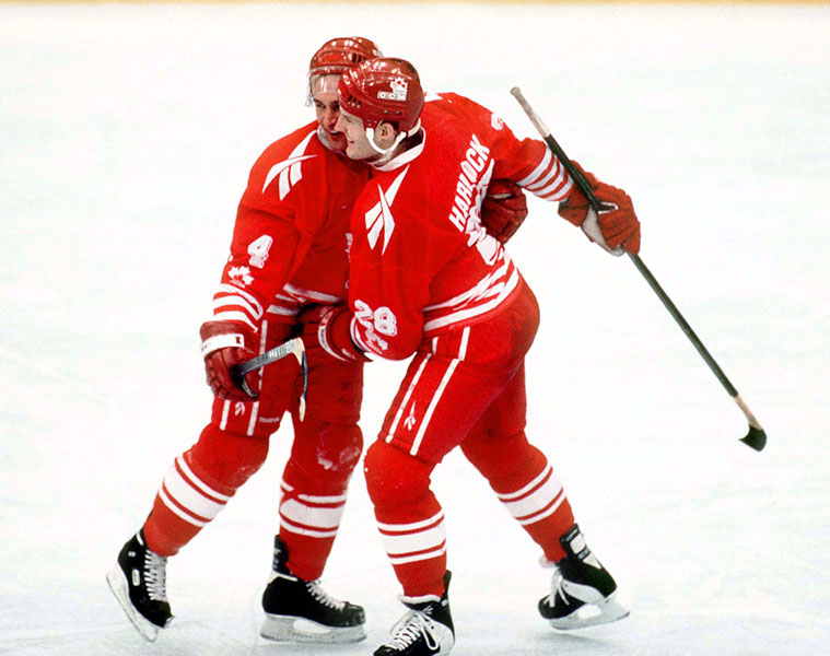 Canada's Derek Mayer (left) and David Harlock compete in hockey action at the 1994 Winter Olympics in Lillehammer. (CP Photo/COA/Claus Andersen)
