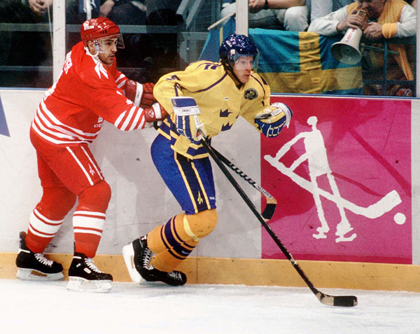 Canada's Derek Mayer (left) competes in hockey action against Sweden at the 1994 Winter Olympics in Lillehammer. (CP Photo/COA/Claus Andersen)