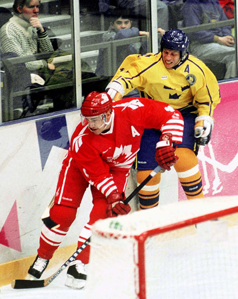 Canada's Derek Mayer (red) competes in hockey action at the 1994 Winter Olympics in Lillehammer. (CP Photo/COA/Claus Andersen)
