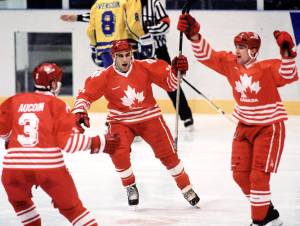(From left to right) Canada's Adrian Aucoin, Dwayne Norris and Todd Hlushko celebrate during hockey action against Sweden at the 1994 Winter Olympics in Lillehammer. (CP Photo/COA/Claus Andersen)