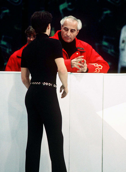Canada's Kurt Browning chats with coach Lewis Stong during figure skating competition at the 1994 Lillehammer Winter Olympics. (CP Photo/COA/F. Scott Grant)