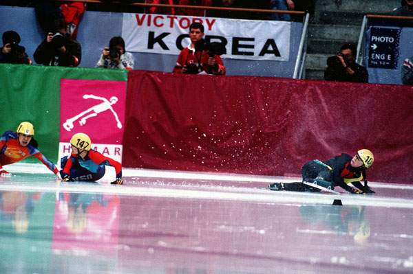 Canada's Isabelle Charest (right) falls during the short track speed skating event at the 1994 Lillehammer Winter Olympics. (CP Photo/ COA/F. Scott Grant)