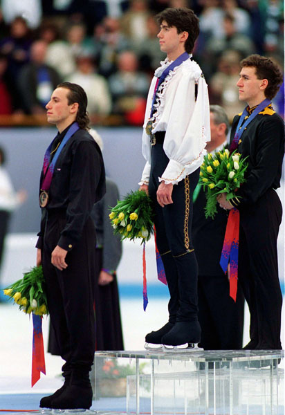 Canada's Elvis Stojko (right) celebrates his silver medal in the men's figure skating event at the 1994 Lillehammer Winter Olympics. (CP Photo/COA/F. Scott Grant)