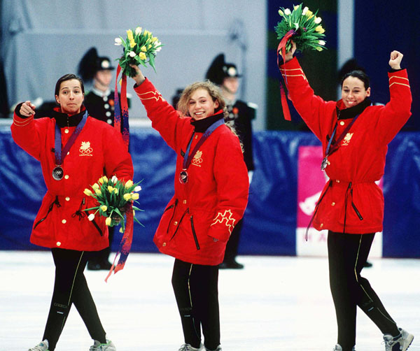 Canada's women short track speed sketing relay team, (from left) Sylvie Daigle, Christine Boudrias and Nathalie Lambert, celebrates its silver medal win at the 1994 Lillehammer Winter Olympics. (CP Photo/COA/F. Scott Grant)