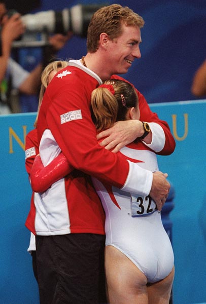 Canada's Julie Beaulier receives a hug from her coach at the 2000 Sydney Olympic Games. (CP Photo/ COA)