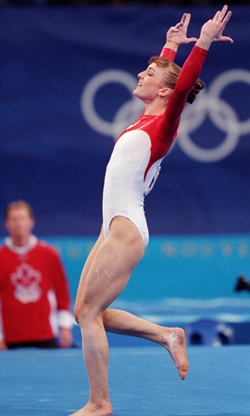 Canada's Lise Leveille performs her floor routine as her coach watches in the background during the gymnastic portion of the 2000 Sydney Olympic Games. (CP Photo/ COA)