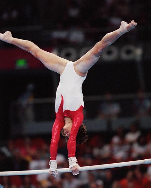 Canada's Yvonne Tousek performs her routine on the uneven bars at the 2000 Sydney Olympic Games. (CP Photo/ COA)