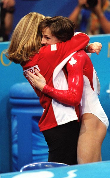 Canada's Yvonne Tousek receives a hug from her coach at the 2000 Sydney Olympic Games. (CP Photo/ COA)