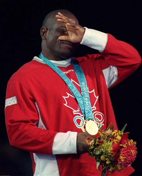 Canada's Daniel Igali wipes away a tear after having won a gold medal in wrestling at the 2000 Sydney Olympic Games. (CP Photo/ COA)