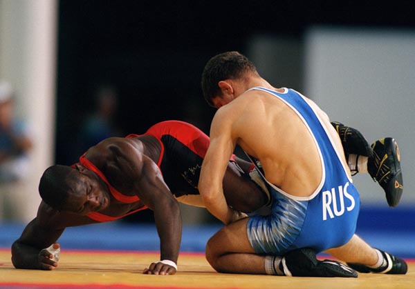 Canada's Daniel Igali wrestling against his opponent Arsen Gitinov of Russia at the 2000 Sydney Olympic Games. (CP Photo/ COA)