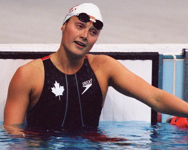 Canada's Marianne Limpert catches her breath by the edge of the pool at the 2000 Sydney Olympic Games. (CP Photo/ COA)