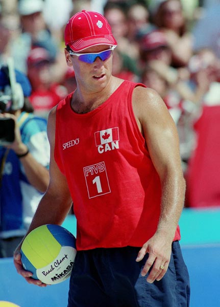 Canada's John Child prepares to serve the ball during a match of beach volleyball at the 2000 Sydney Olympic Games. (CP Photo/ COA)