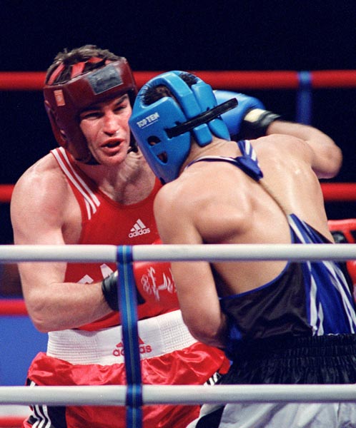 Canada's Mike Strange battles his opponent in the ring at the 2000 Sydney Olympic Games. (CP Photo/ COA)