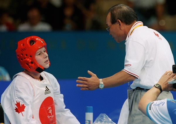Canada's Dominique Bosshart talks with her taekwondo coach Joo Won Kang at the 2000 Sydney Olympic Games. (Mike Ridewood/CP Photo/ COA)