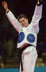 Canada's Dominique Bosshart raises her hands in victory after winning her round of taekwondo at the 2000 Sydney Olympic Games. (Mike Ridewood/CP Photo/ COA)