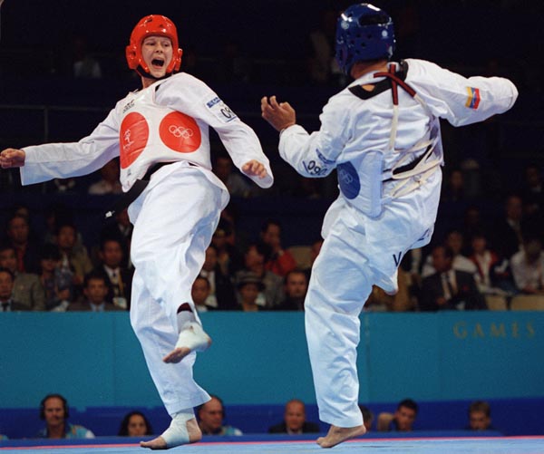 Canada's Dominique Bosshart in action against her taekwondo opponent at the 2000 Sydney Olympic Games. (Mike Ridewood/CP Photo/ COA)