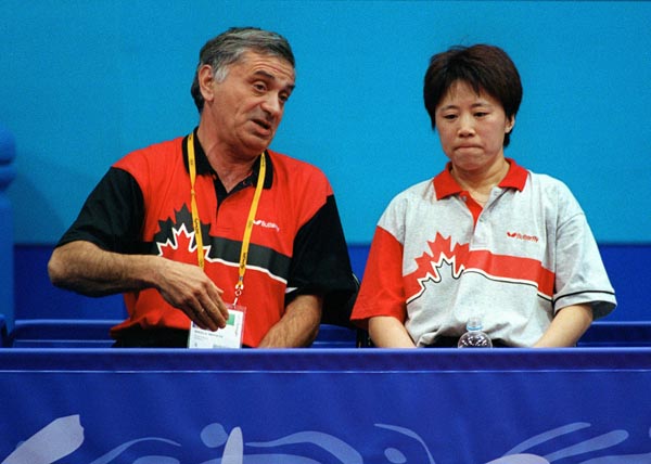 Canada's Lijuan Geng and her coach Michel Gadal talk during a break from table tennis play at the 2000 Sydney Olympic Games. (Mike Ridewood/CP Photo/ COA)