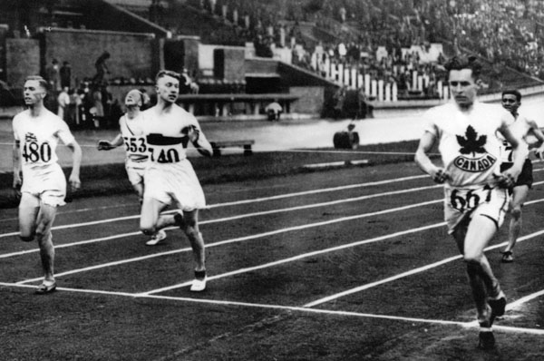 Canada's Percy Williams (667) crosses the finish line  in an athletics event at the 1928 Amsterdam Olympics. Williams won gold medals in the 100m and the 200m events (CP Photo/COA)
