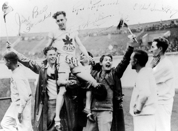 Canada's Percy Williams (667) is carried by his coutrymen in an athletics event at the 1928 Amsterdam Olympics. Williams won gold medals in the 100m and the 200m events. (CP Photo/COA)