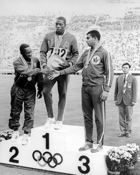 Canada's Harry Jerome (right) celebrates his bronze medal win in the 100m athletics event at the 1964 Tokyo Olympics. (CP Photo/COA)