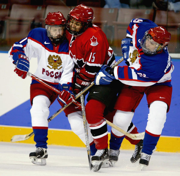 Canada's Danielle Goyette of St-Nazaire, Que. gets squeezed out of the play by Russia's Svetlana Trefilova (left) and Zhanna Shchelchkova during the second period of  a 7 - 0 Canadian win over Russia  at the Winter Olympics in West Valley City, Utah, Wed.