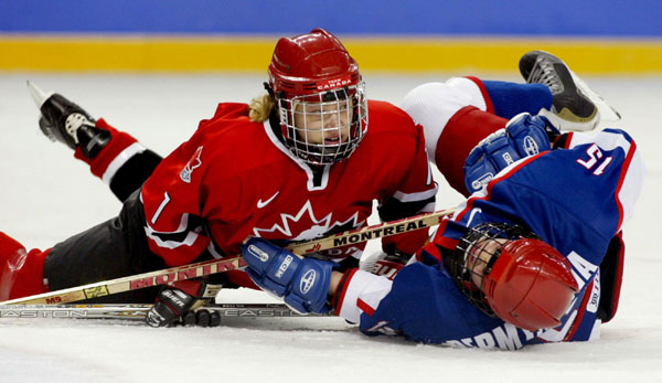 Cherie Piper (left) of Canada takes out Russia's Olga Permyakova during the first period of a 7 - 0 team Canada win over Russia  at the Winter Olympics in Salt Lake City, Utah, Wed., Feb. 13, 2002. (CP Photo/COA/Mike Ridewood)