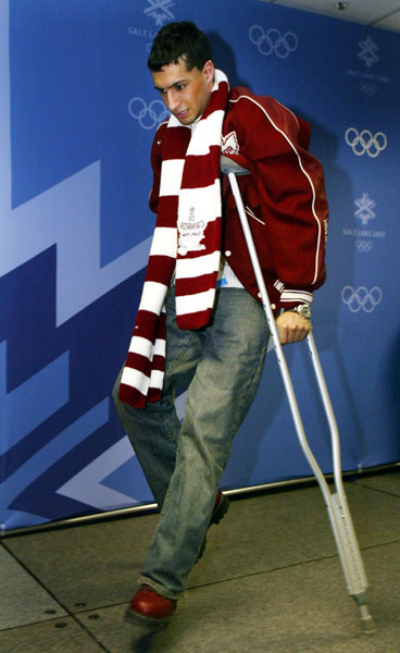 Canadian Figure Skater Emanuel Sandhu leaves a news conference on crutches after announcing his withdrawal from Mens Figure Skating due to injury in Salt Lake City, Utah Tuesday Feb. 12, at the 2002 Winter Olympic Games. (CP Photo/COA/Andre Forget)