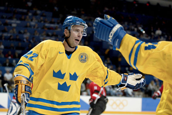 Ulf Dahlen (22) of Sweden celebrates his goal, Sweden's fifth, with Niklas Sundstrom in the second period of a 5 - 2 Swedish win in men's hockey action at the Winter Olympics in Salt Lake City, Fri., Feb. 15, 2002.  (CP PHOTO/COA/Mike Ridewood)