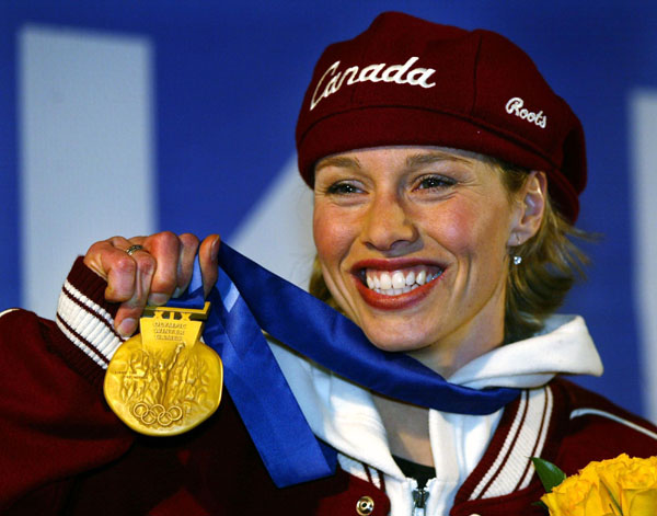 Canadian gold medallist in the women's 500m speed skating, Catriona Le May Doan, shows off her medal in Salt Lake City, Utah Friday Feb. 15, at the 2002 Winter Olympic Games.   (CP PHOTO/COA/Andre Forget)