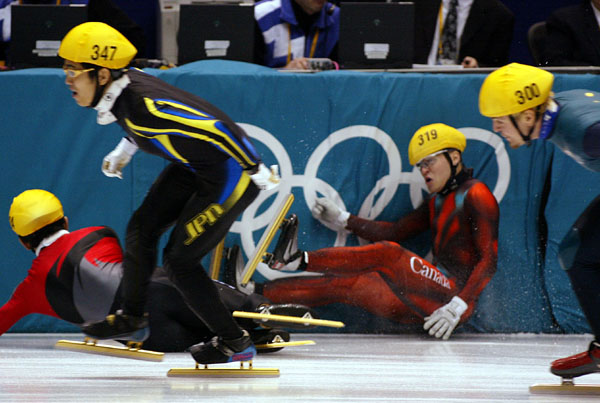 Mathieu Turcotte (319) slams into the wall as Jiajun Li from China takes him out during the Mens 1000 metre Semi Final in Salt Lake City, Utah Saturday Feb. 16, at the 2002 Winter Olympic Games.  (CP Photo/COA/Andre Forget)