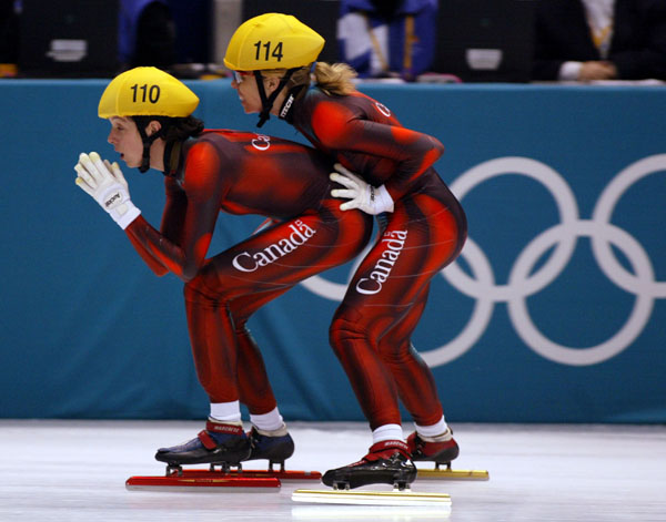 Canadian short track speed skater Tania Vicent (114) pushes off teammate Marie-Eve Drolet (110)  during the Ladies 3,000 metre heat in Salt Lake City, Utah Saturday Feb. 16, at the 2002 Winter Olympic Games. (CP Photo/COA/Andre Forget)