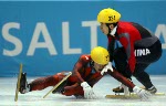 Mathieu Turcotte (319)  is taken down by Jiajun Li from China during the Mens 1000 metre Semi Final in Salt Lake City, Utah Saturday Feb. 16, at the 2002 Winter Olympic Games.  (CP Photo/COA/Andre Forget)