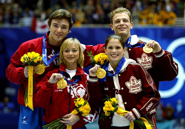 Gold medalists David Pelletier and Jamie Sale stand next to Russians Anton Sikharulidze and Elena Berezhnaya as they show off thier gold medals Sunday Feb. 17, at the 2002 Winter Olympic Games.  (CP Photo/COA/Andre Forget)