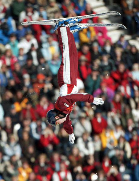 Deidra Dionne of Red Deer, Alta.  flies over the crowd on her first jump on her way to a bronze medal in women's aerials at Deer Valley, Utah during the Winter Olympics, Mon., Feb. 18, 2002.  (CP PHOTO/COA/Mike Ridewood)