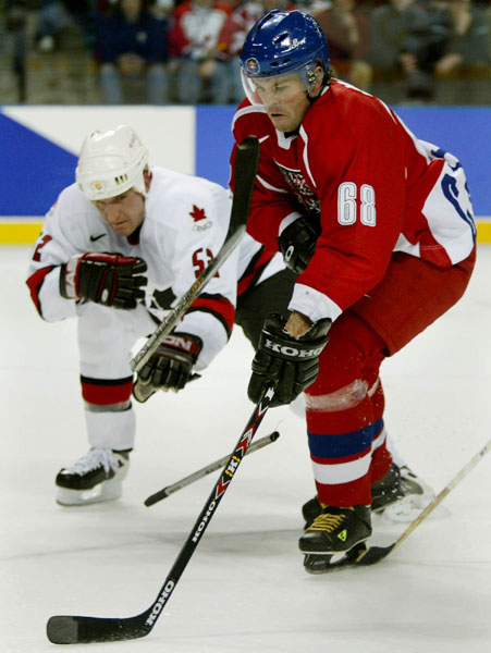 Canadian Adam Foote (left) breaks his stick trying to stop Czech Jaromir Jagr Monday Feb. 18, at the 2002 Winter Olympic Games in Salt Lake City.  (CP Photo/COA/Andre Forget)