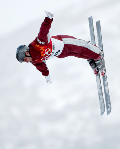 Steve Omischl of North Bay flies over Deer Valley, Utah, and finished eleventh in the men's aerials final at during the Winter Olympics, Tues., Feb. 19, 2002.  Bean was the top Canadian.  (CP PHOTO/COA/Mike Ridewood)