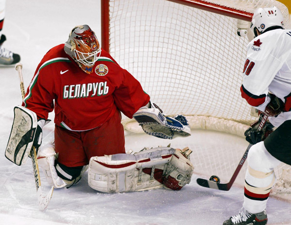 Eric Lindros of Team Canada backhands the puck past Team Belarus goalie Sergei Shabanov during the second period of Olympic hockey action Friday Feb. 22, 2002 at the 2002 Winter Olympic Games in Salt Lake City.  Team Canada went on to win 7-1.   (CP Photo