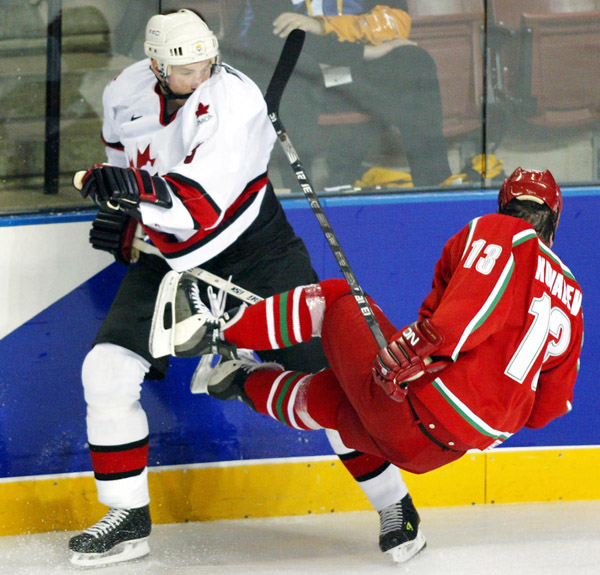 Team Canada's Eric Brewer, of Kamloops, B.C., sends Andrei Kovalev flying during the first period of Olympic hockey action Friday Feb. 22, 2002, at the 2002 Winter Olympic Games in Salt Lake City.  Team Canada went on to win 7-1. (CP Photo/COA/Andre Forge