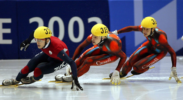 Canadian Short Track skaters Marc Gagnon (315) and Jonathan Guilmette (316) follow on the heals of American Rusty Smith during the Men's 500 metre Saturday Feb. 23, 2002 at the 2002 Winter Olympic Games in Salt Lake City. Canadian Gagnon went on to win go