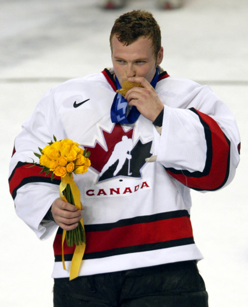 Team Canada goalie Martin Brodeur kisses his gold medal  after they won over Team USA to win the gold medal in hockey Sunday Feb. 24, 2002 at the 2002 Winter Olympic Games in Salt Lake City. Team Canada won 5-2 over Team USA.  (CP Photo/COA/Andre Forget)