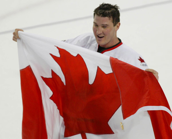 Canada's captain Mario Lemieux holds up the Canadian flag after they won over Team USA to win the gold medal in hockey Sunday Feb. 24, 2002 at the 2002 Winter Olympic Games in Salt Lake City. Team Canada won 5-2 over Team USA.  (CP Photo/COA/Andre Forget)