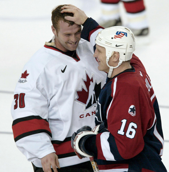 Canada's goaltender Martin Brodeur is congratulated by Brett Hull of the USA after Canada's men's hockey team defeated the U.S. 5 - 2 to take the gold medal at the Winter Olympics in West Valley, Utah, Sun., Feb. 24, 2002 . (CP PHOTO/COA/Mike Ridewood)