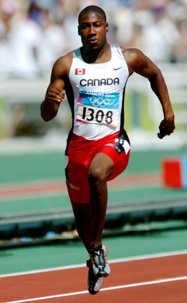 Canadian sprinter Pierre Brown of Toronto, Ontario, runs during the 100m heat during the Athens 2004 Summer Olympic Games Saturday, August 21, 2004. Brown crossed the line with a time of 10.32 to move on. (CP PHOTO/COC-Andre Forget)